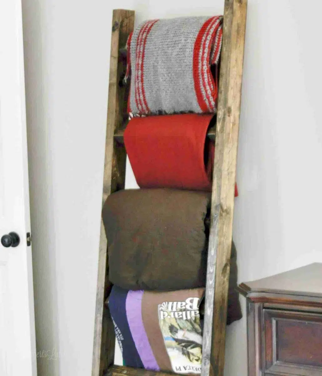 blanket ladder full of blankets leaning against a wall.