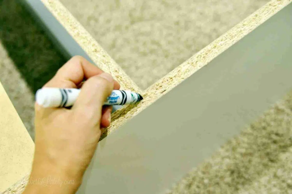 marking back of cabinet with a marker.