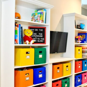 ikea billy bookcase built-ins with colorful bins in a playroom.