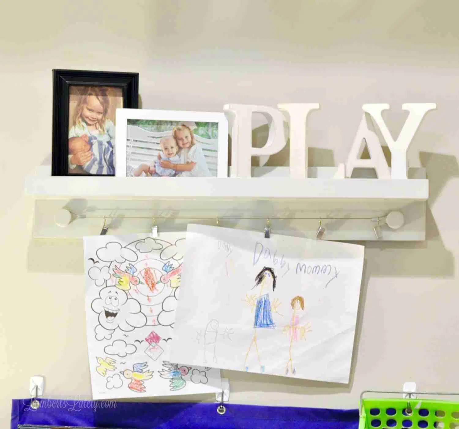 photos, kids\' art, play letters on a shelf.