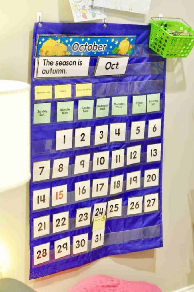 blue pocket calendar hanging on a wall.