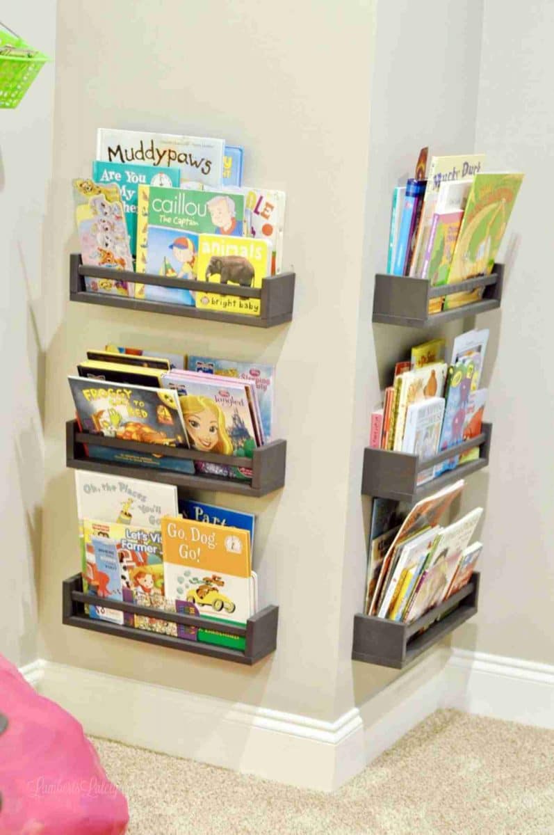 Ikea spice racks turned into gray shelves holding books in a corner.