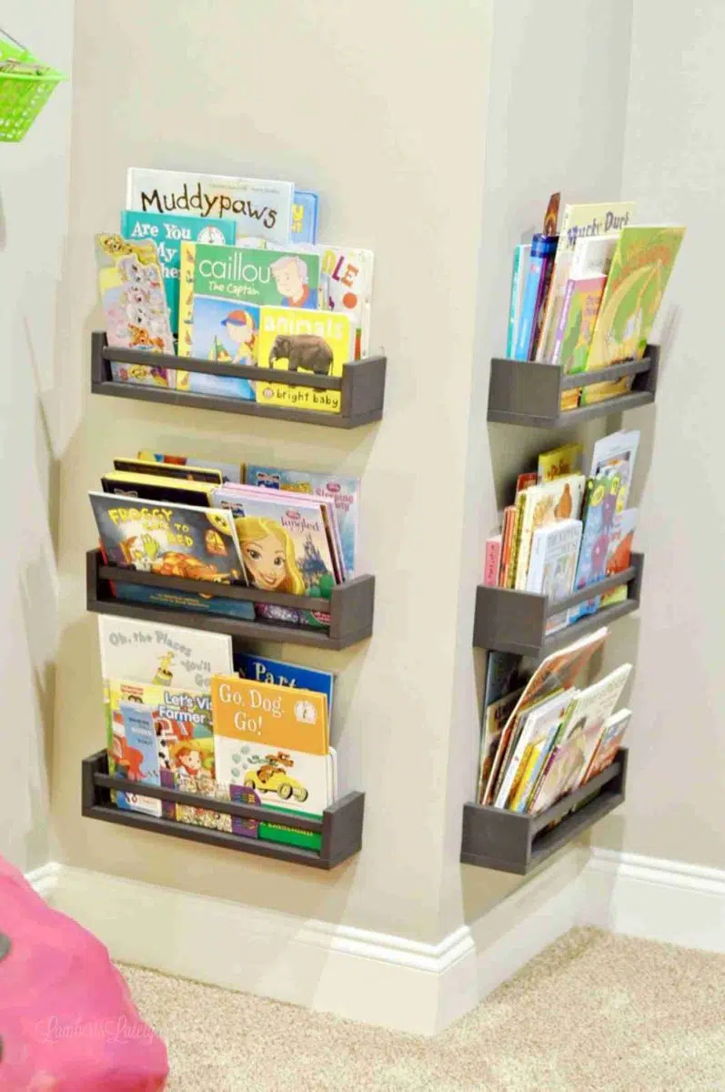 Ikea spice racks turned into gray shelves holding books in a corner.