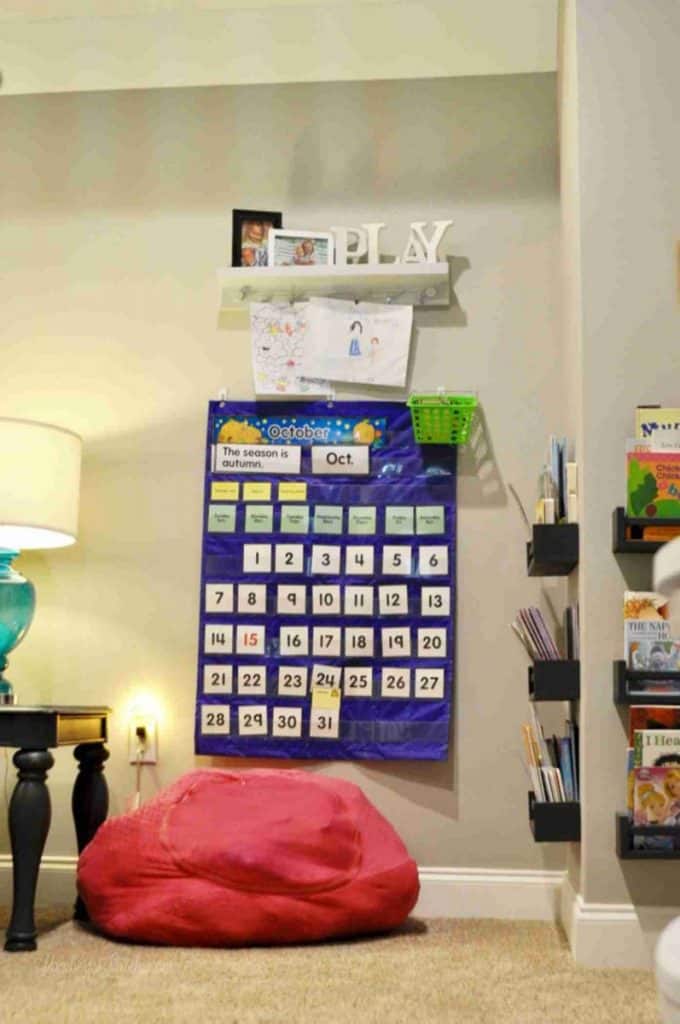 bean bag seat, calendar, art in a playroom.