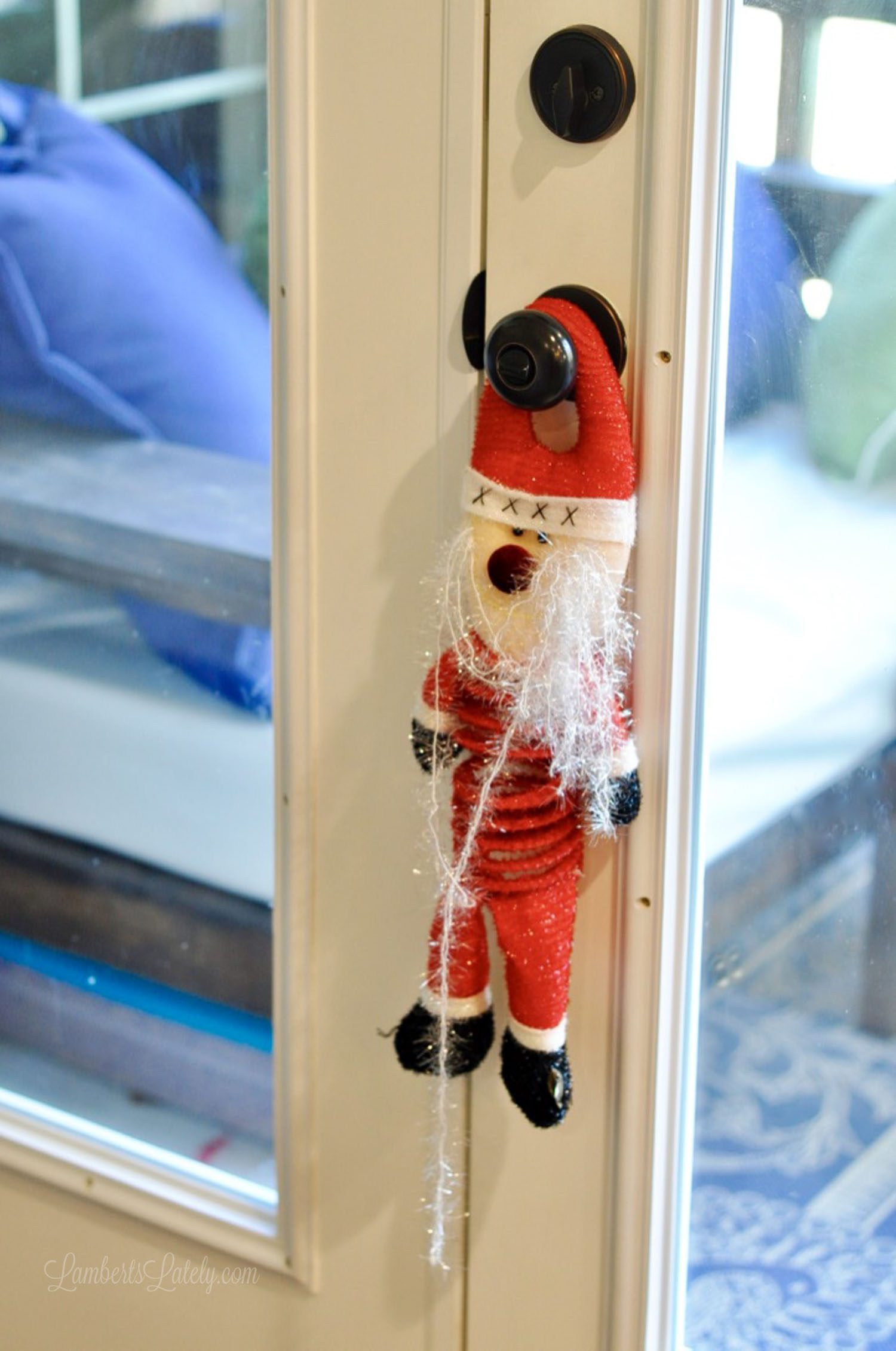 santa claus figure hanging on a doorknob.