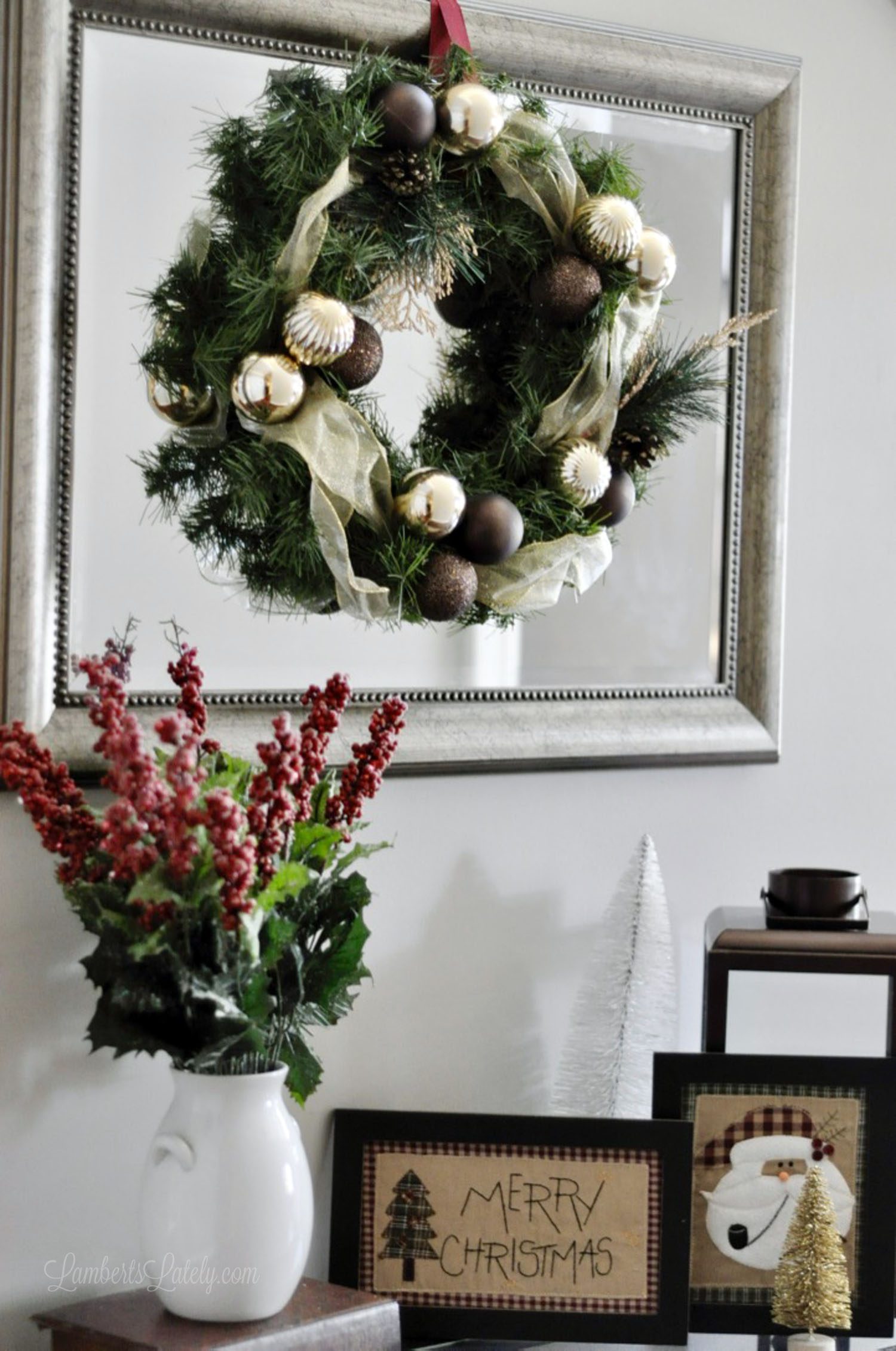 foyer table with mirror, christmas wreath on front.