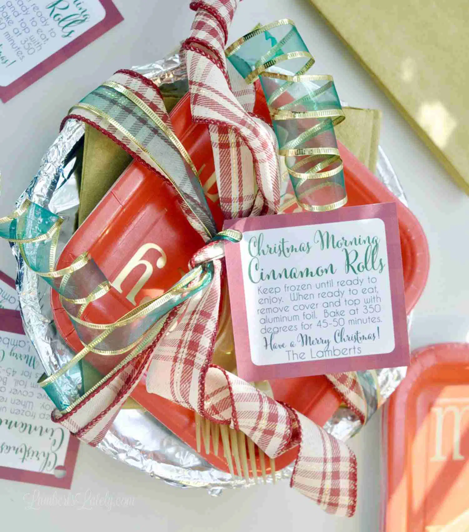 Christmas morning cinnamon rolls packaged in an aluminum dish with a gift tag