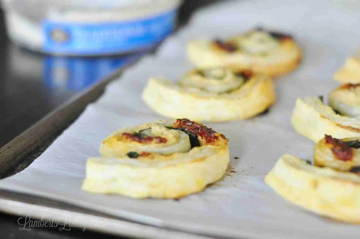 baked hummus pinwheels on a baking sheet lined with parchment paper.