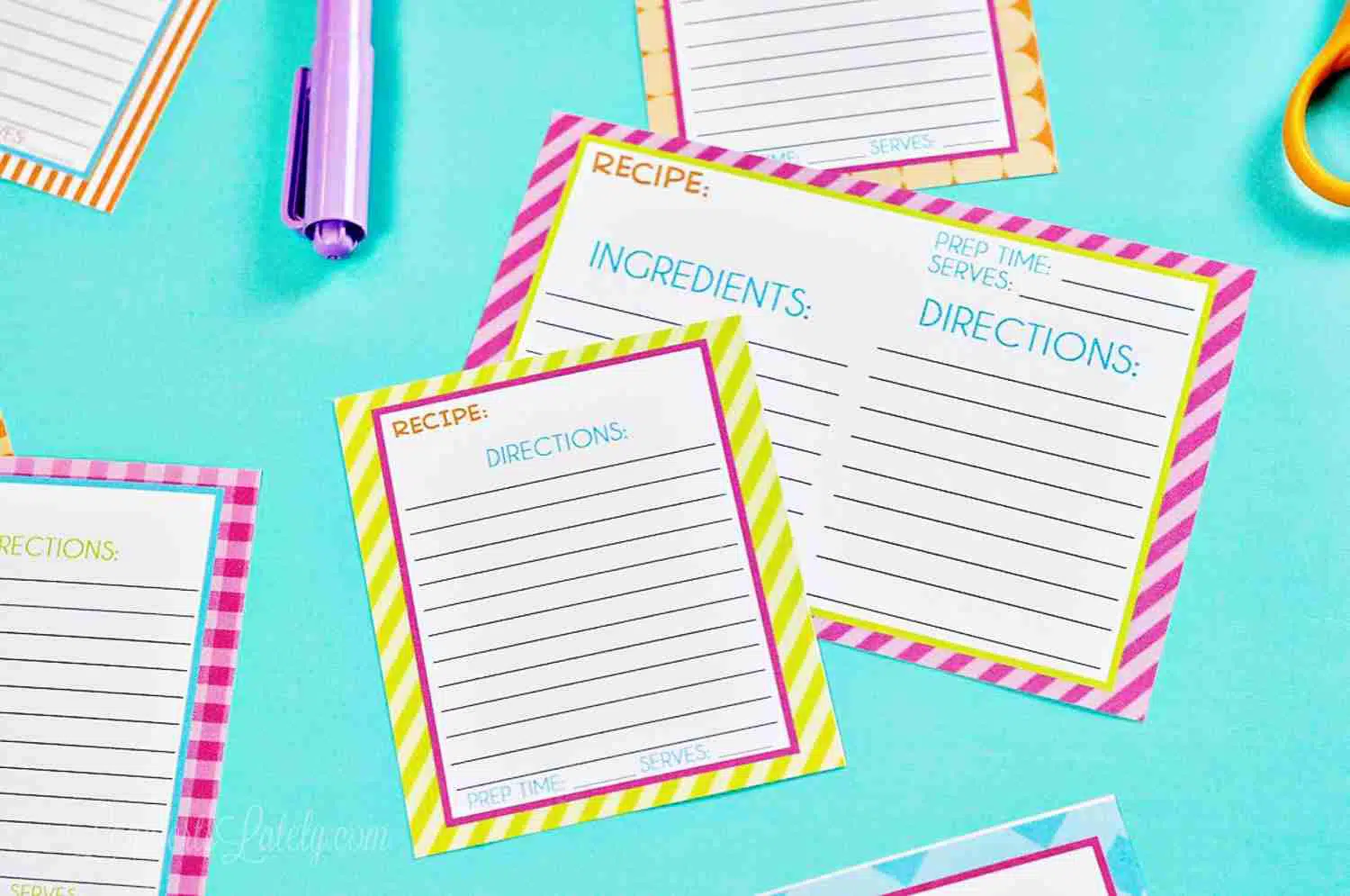 recipe cards and office supplies on a blue background.