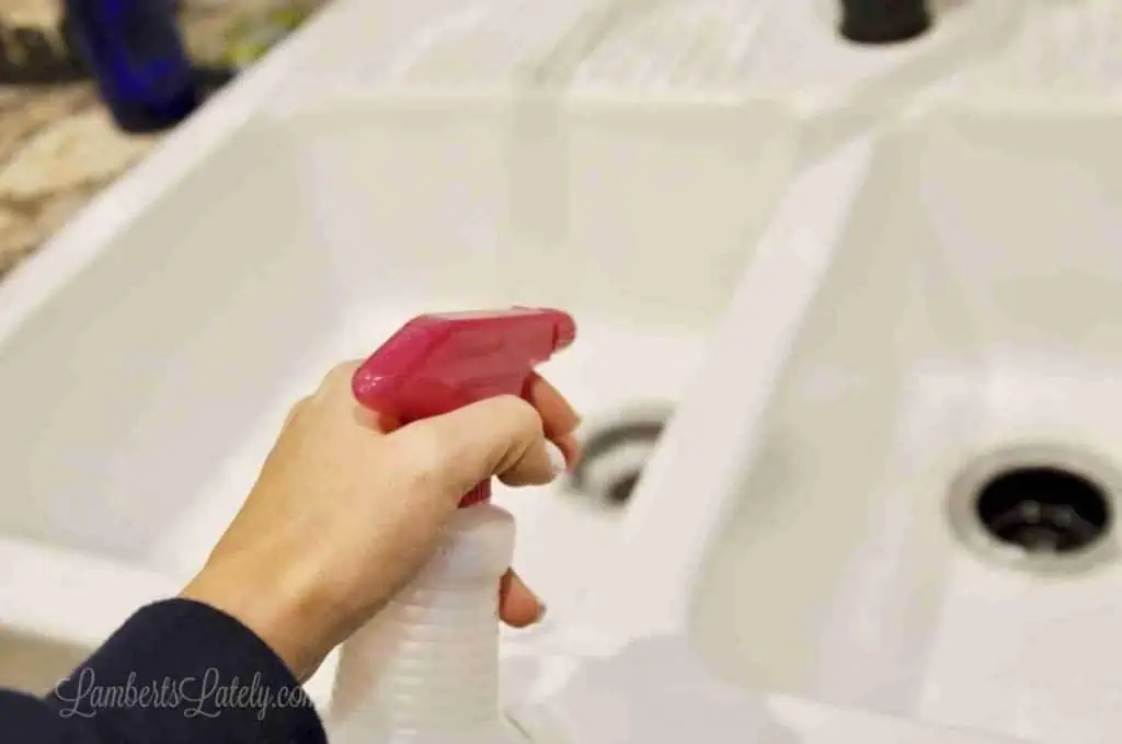 spraying sink with vinegar.