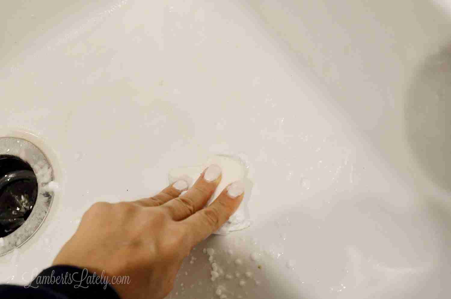 how to clean a porcelain sink - scrub with melamine sponge