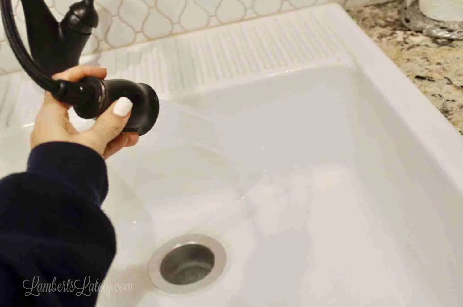 spraying sink with water.