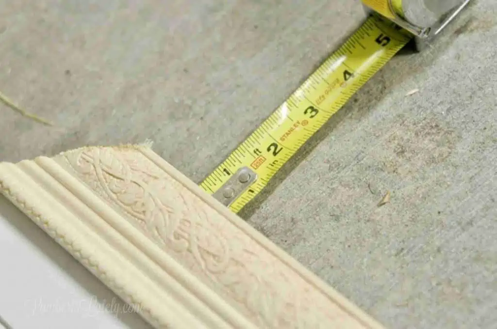 measuring edge of smaller piece of molding.