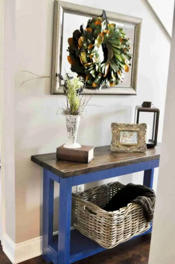 blue and brown console table in a foyer.