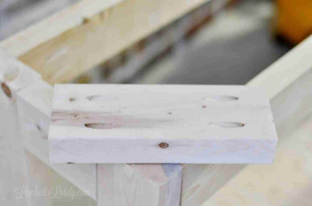 small piece of wood with four pocket holes in the corners.