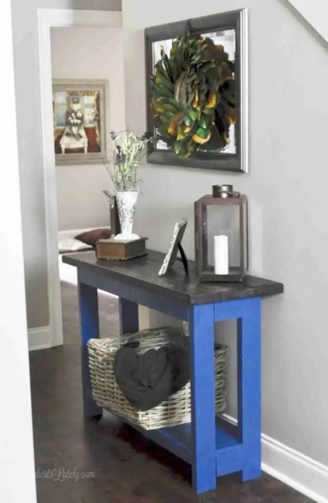 blue and brown console table in a foyer.