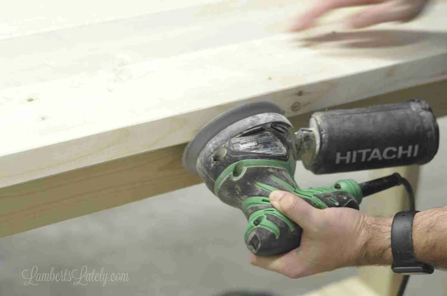 sanding a console table.