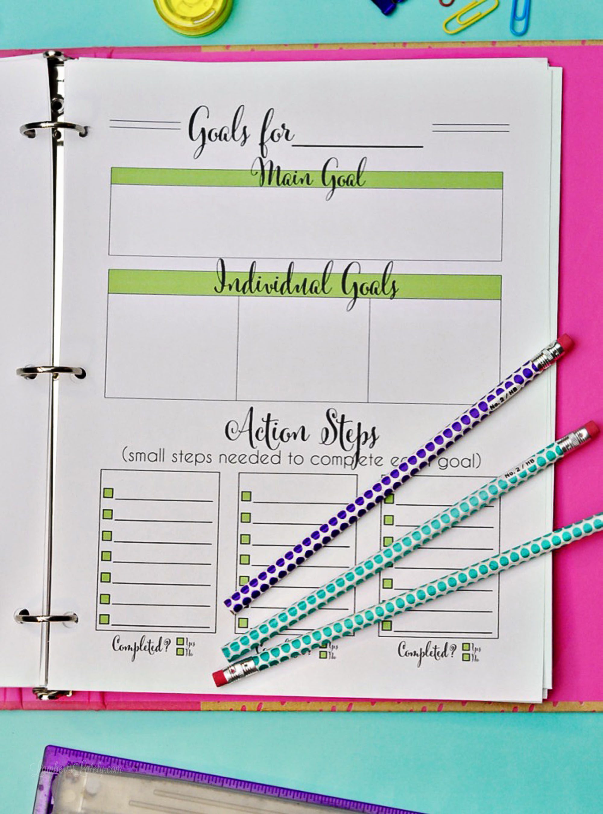 goal planning worksheet in a pink binder.
