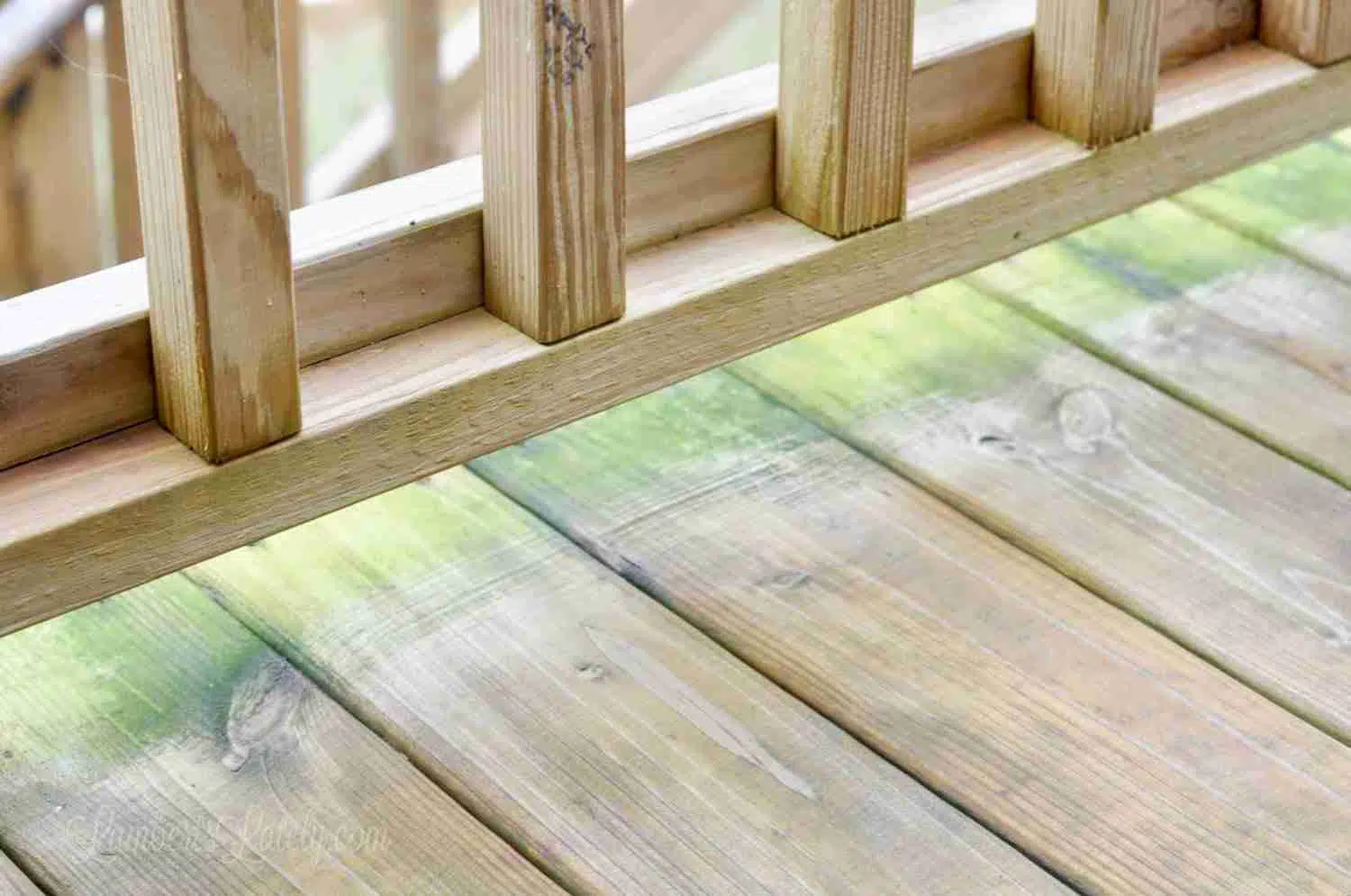 green stains under railing on a deck.