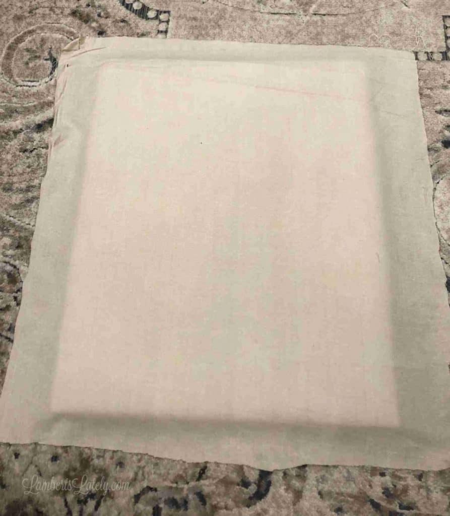 brown fabric laid out under the back of a frame.