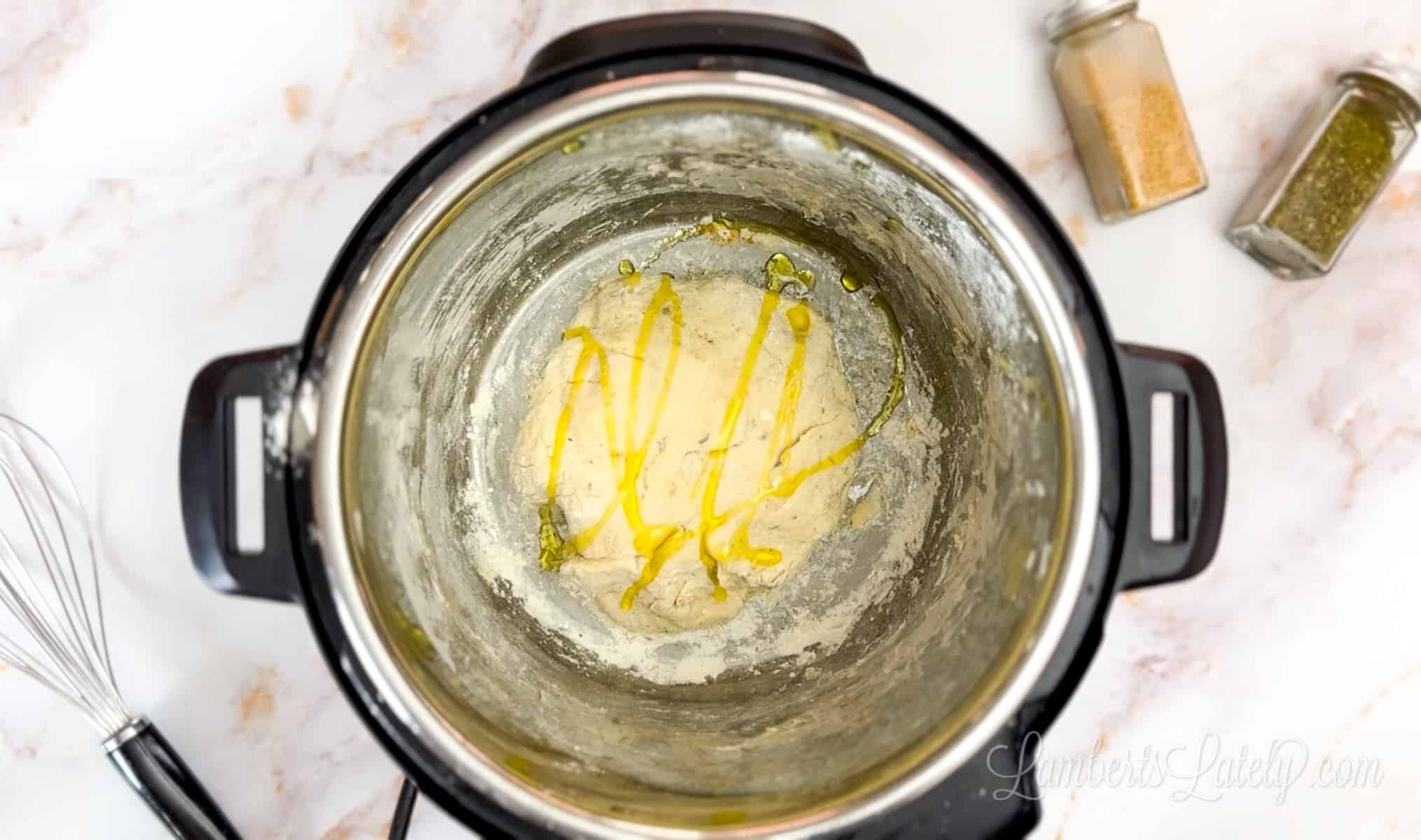 oil poured over ball of dough in an instant pot.