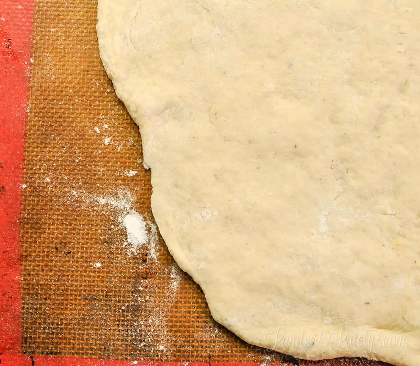 pizza dough spread on a cookie sheet.