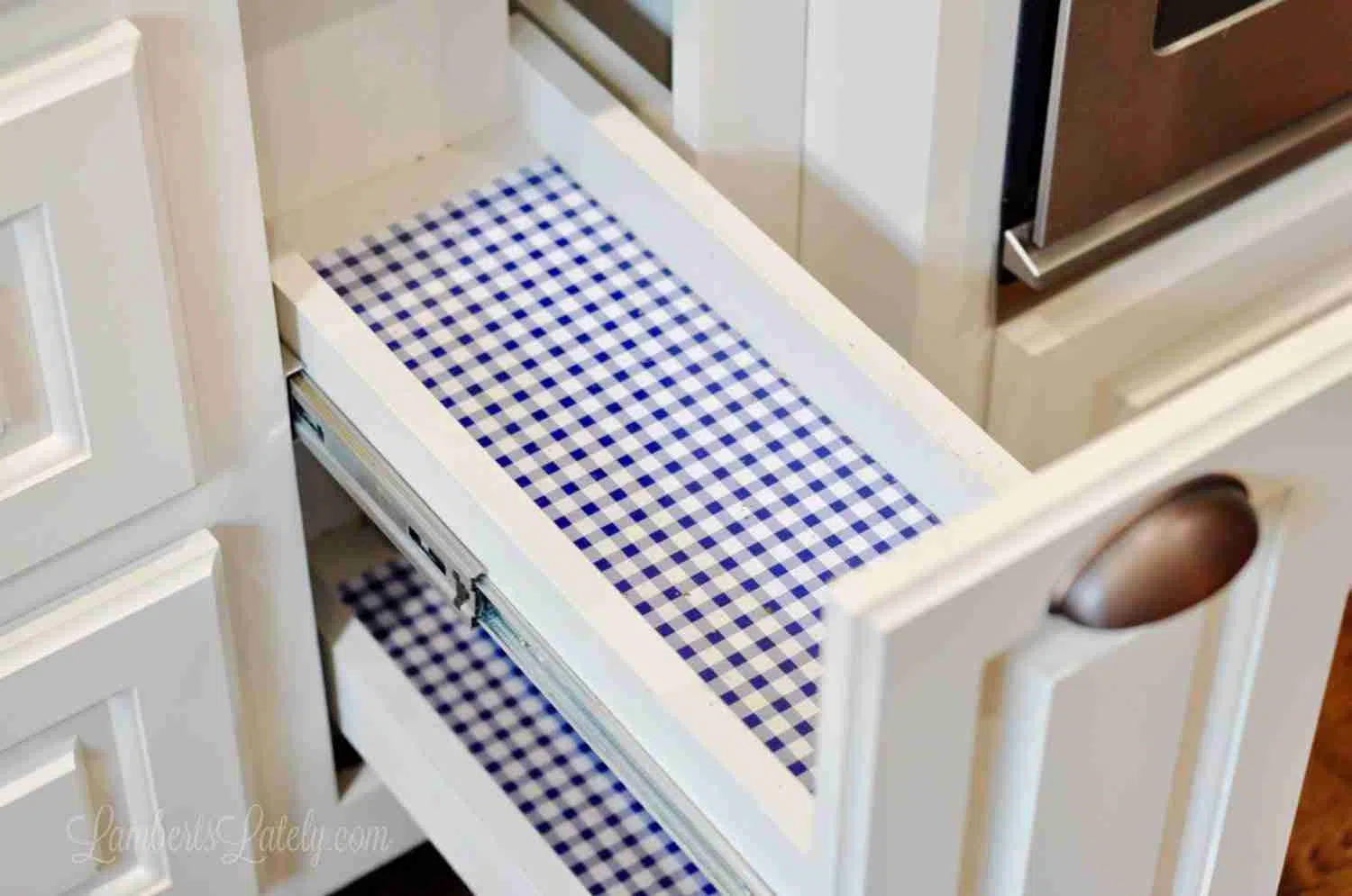 spice cabinet lined with blue gingham contact paper.