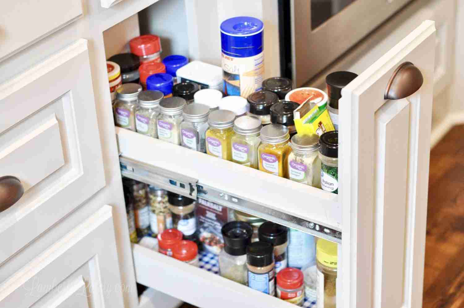 unorganized spices in a spice cabinet.