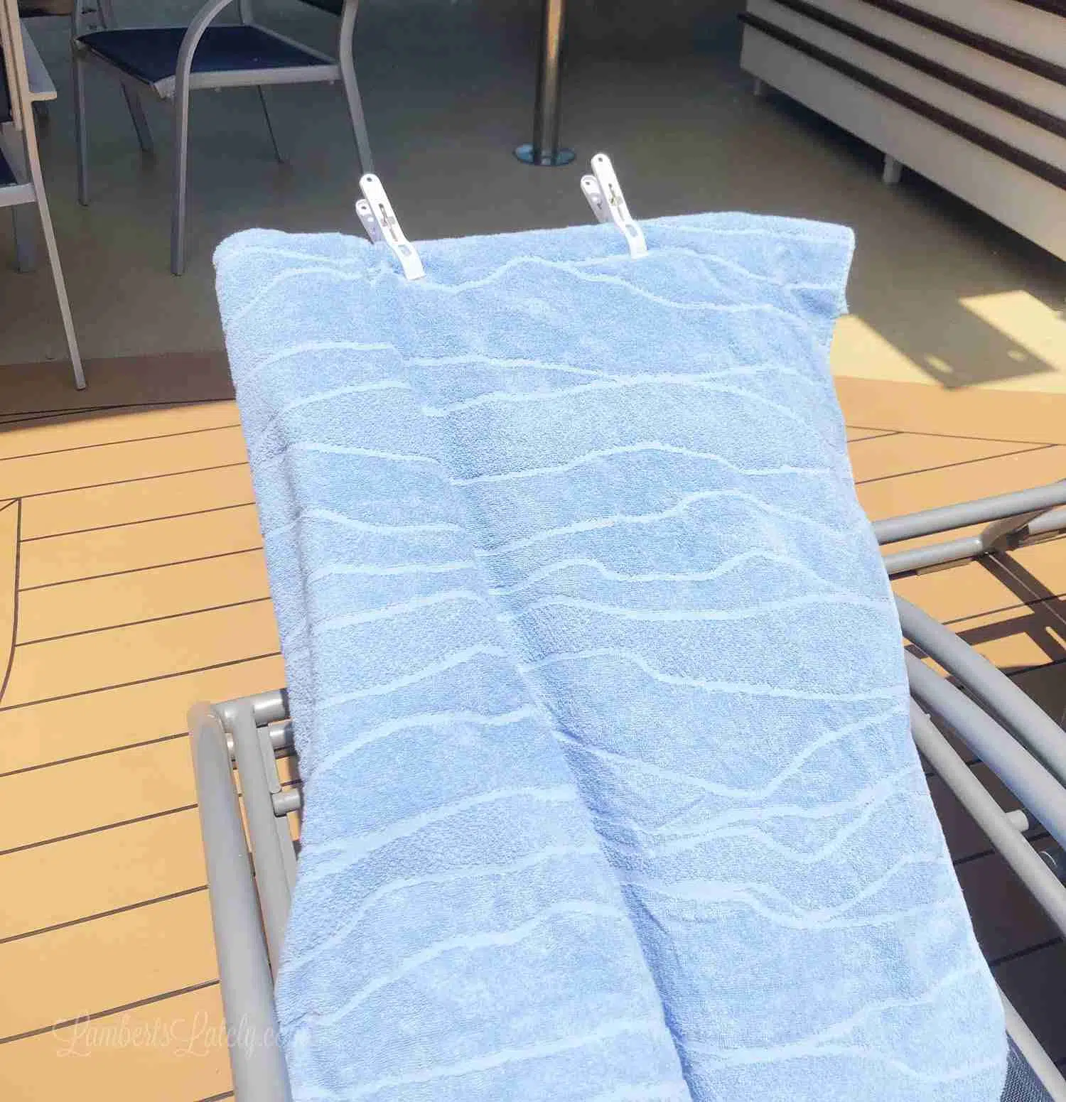 towel with clips on a lounge chair.