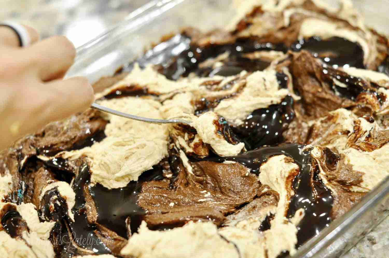 swirling chocolate and peanut butter in a baking dish.