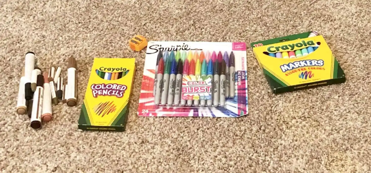 markers sorted on a carpeted floor.