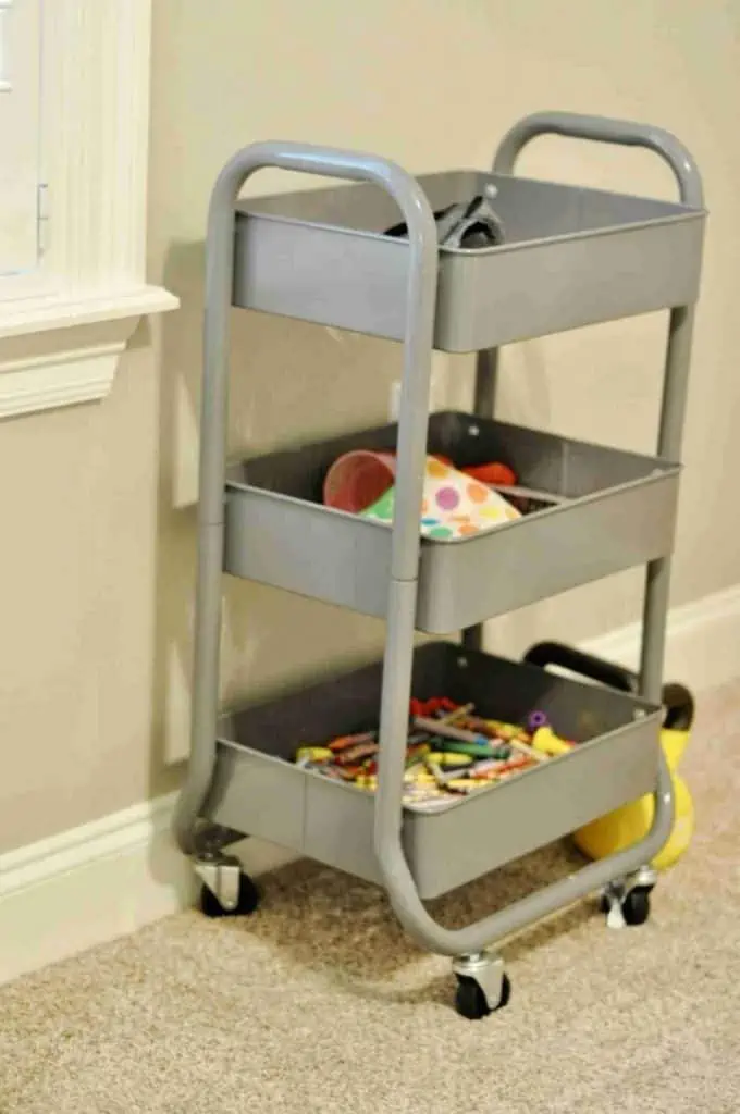 gray metal rolling organizer holding craft supplies.