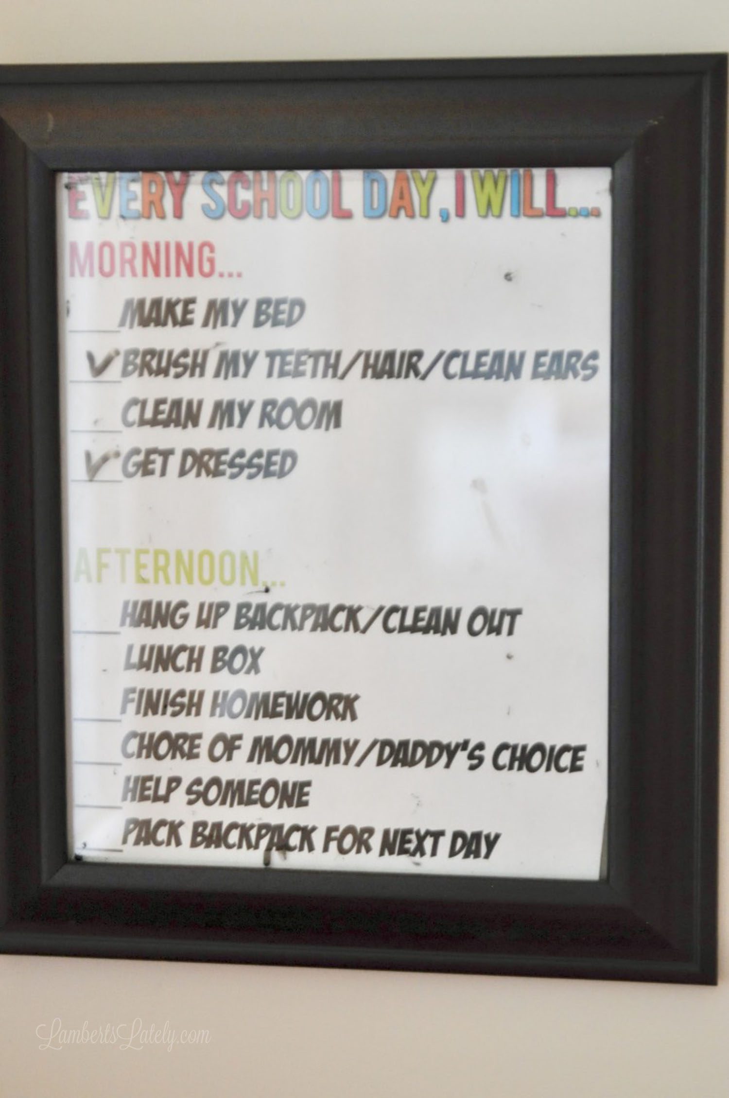 chore chart framed on a wall.