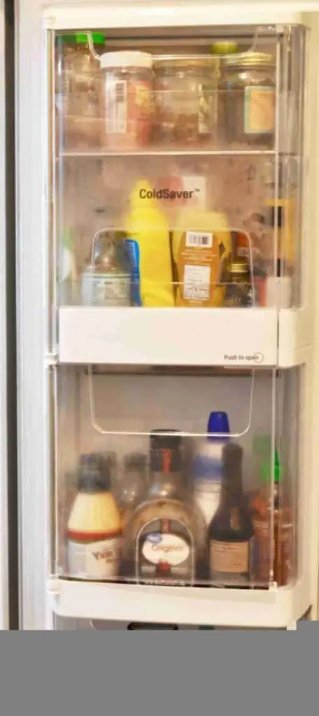 refrigerator door filled with condiments