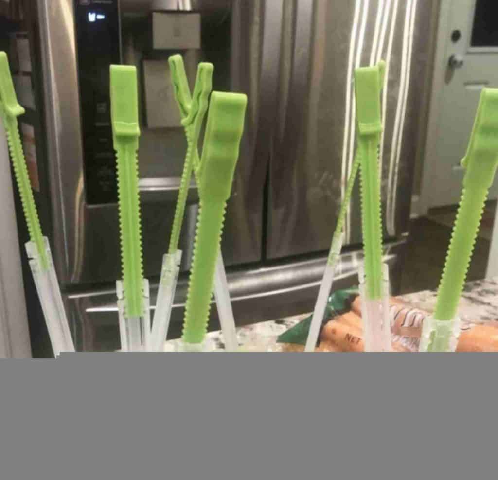 green plastic bag openers on a counter.