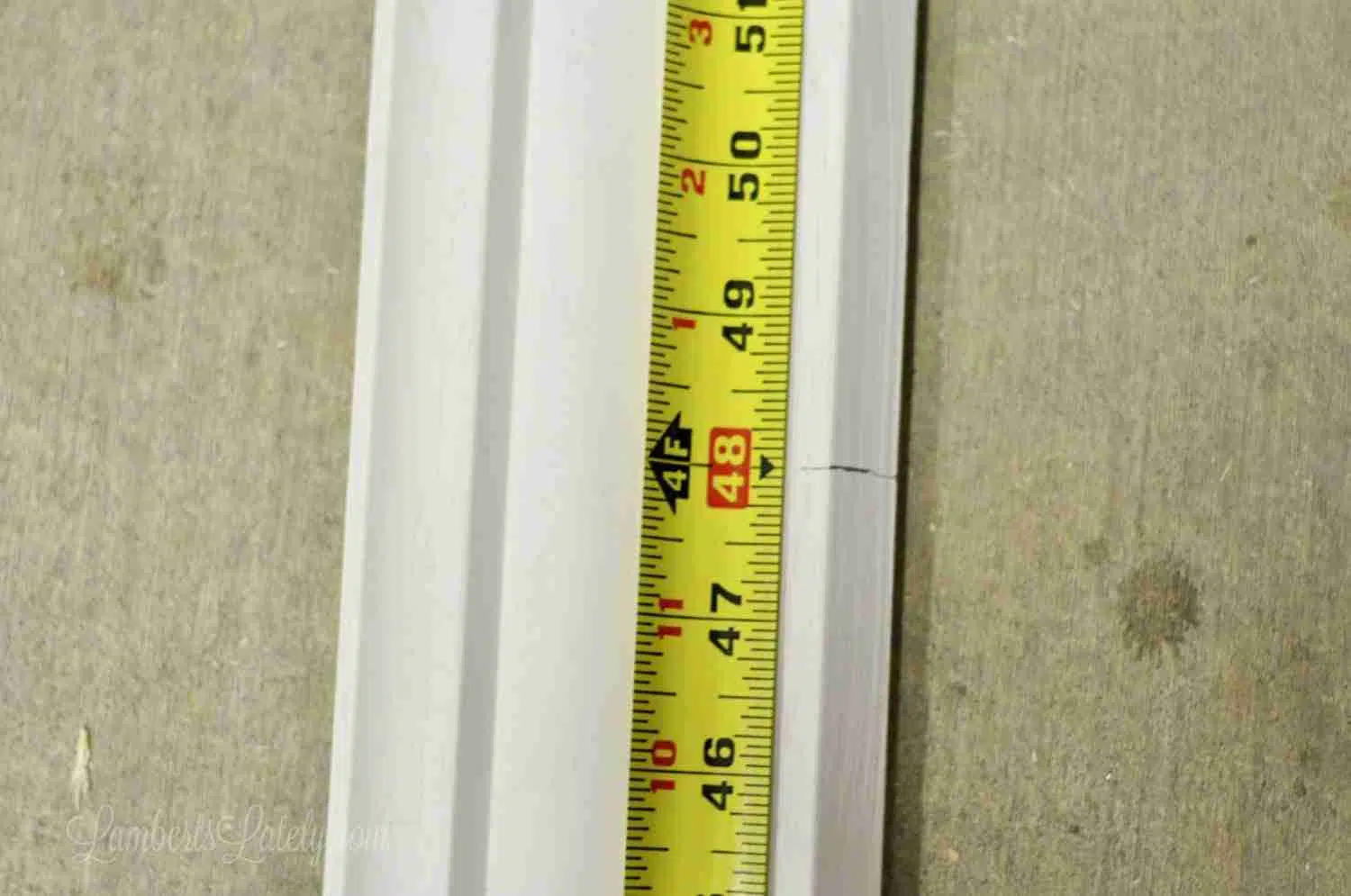 measuring tape on top of piece of crown molding