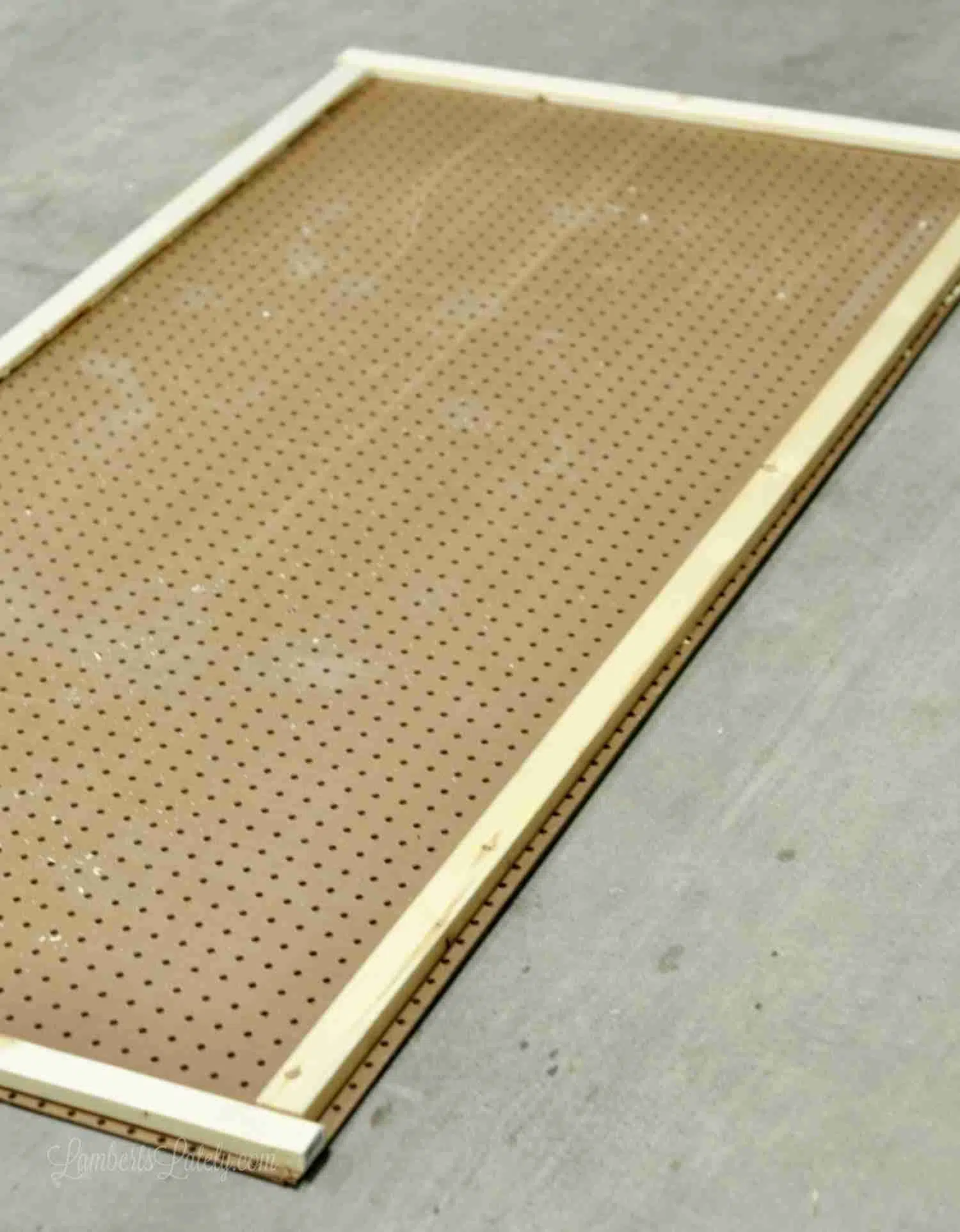 backside of pegboard, lying on the ground, with braces attached to back