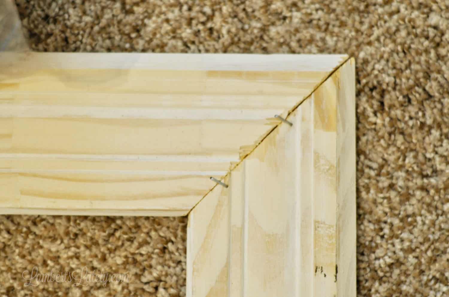 2 pieces of crown molding attached at 45 degree angles with staples.