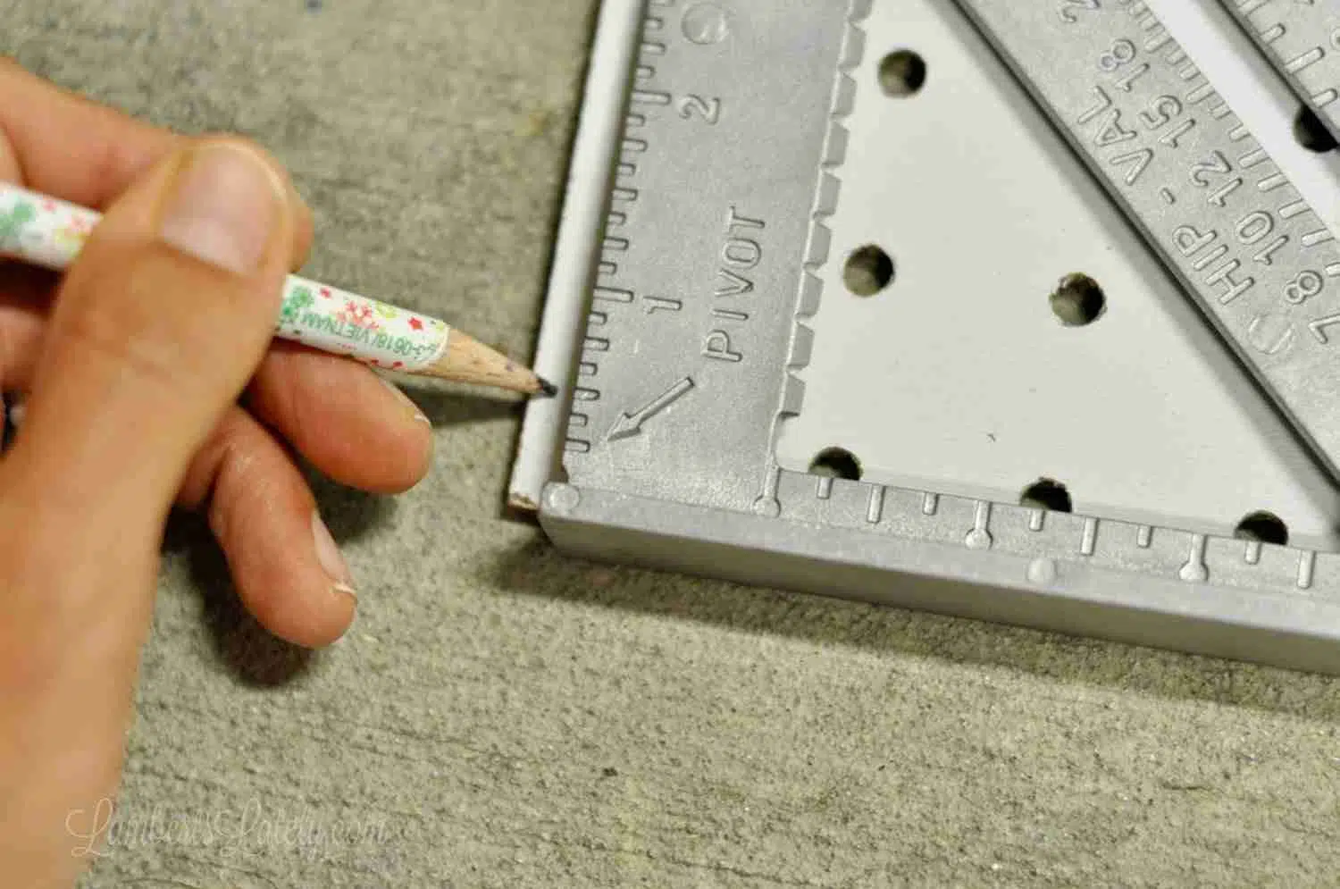 marking piece of pegboard with a pencil