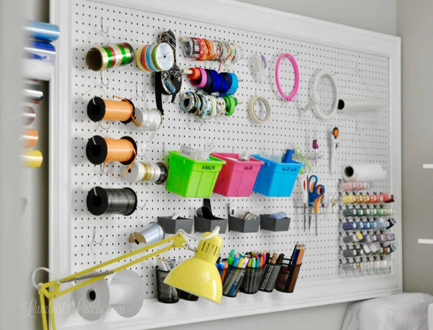 white pegboard filled with colorful crafting supplies.