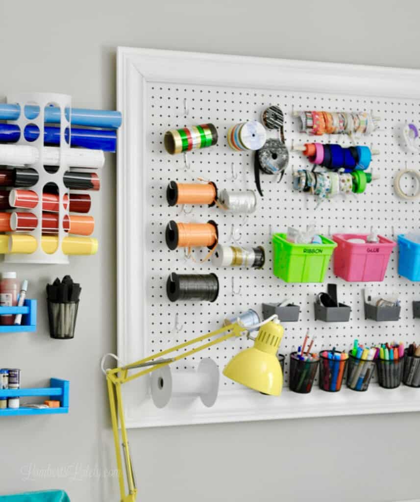 peg board with craft items and vinyl hung on wall.