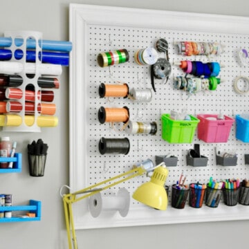 craft room peg board with colorful accessories.