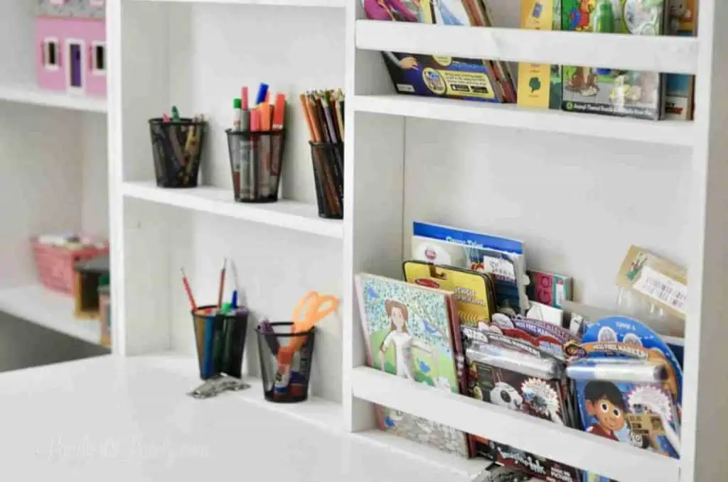 desk on front of murphy bed folded out, holding books and art supplies