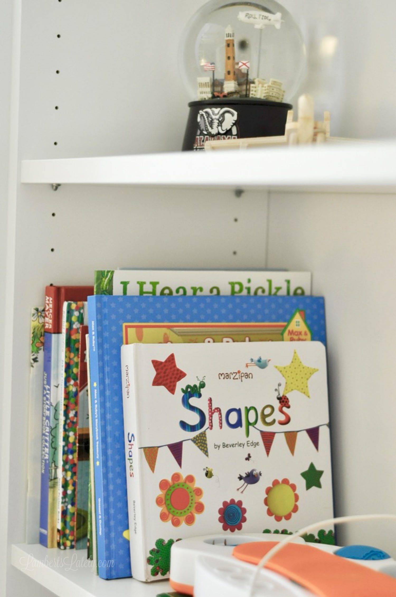 books and a snow globe on a shelf