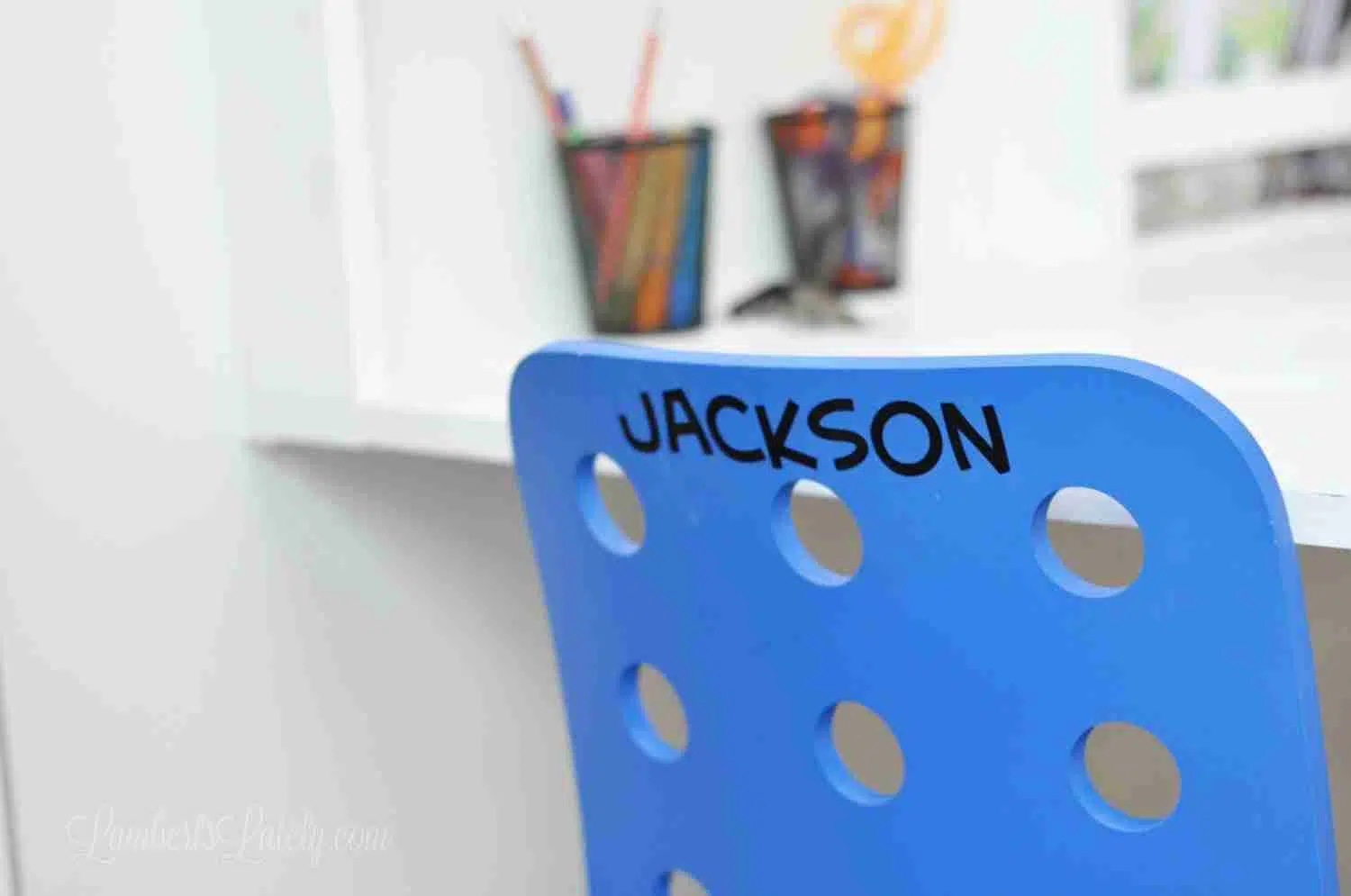 blue rolling chair with Jackson printed on the back