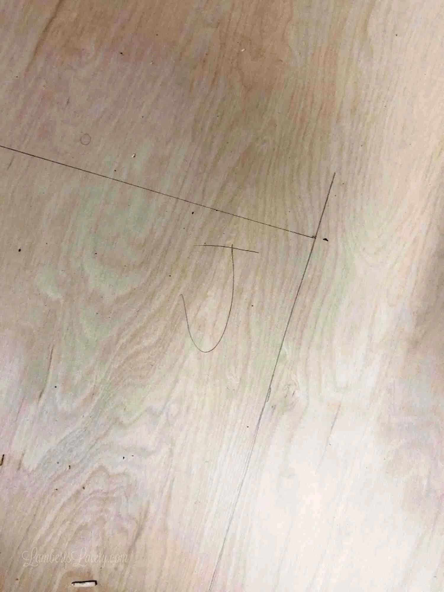90 degree angle penciled on a piece of wood, marked with a J.