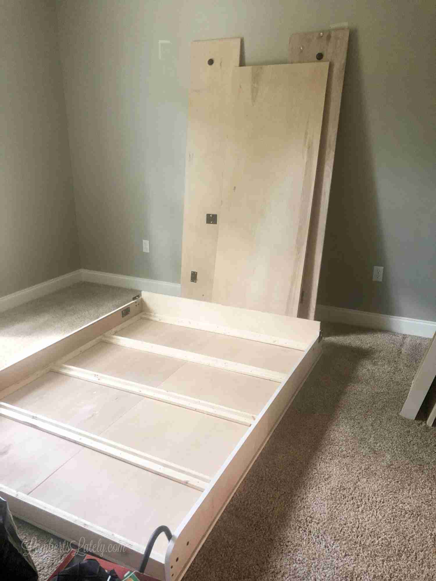 pieces of murphy bed in a bedroom before installing.