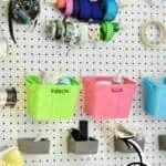 Organized craft room with storage bins, spools, and tools for crafting.
