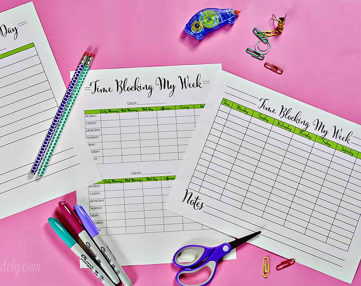 3 time blocking printables on a pink desk.