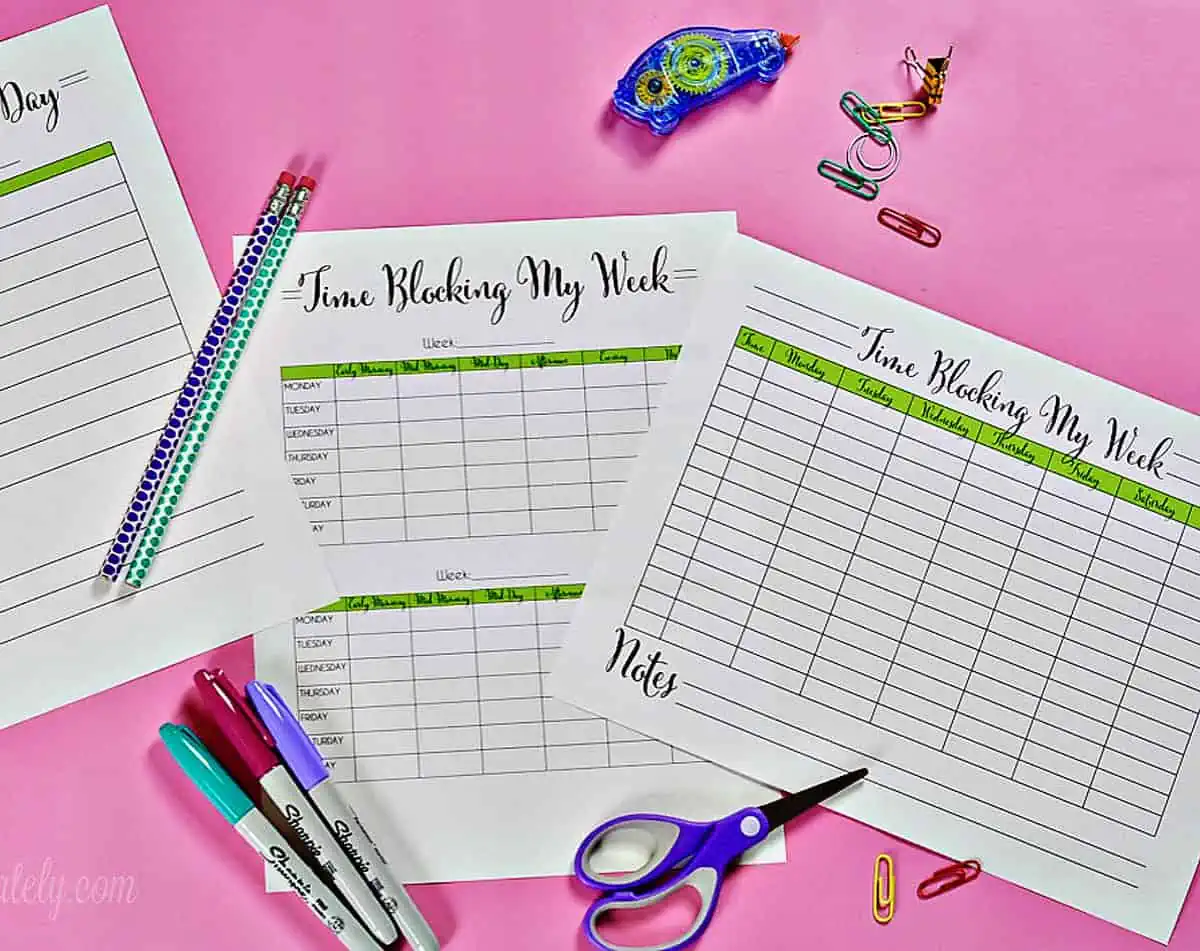 3 time blocking printables on a pink desk.